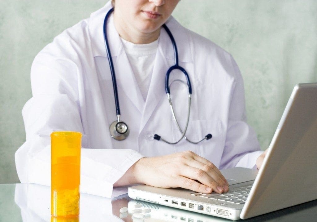 Doctor preparing prescription